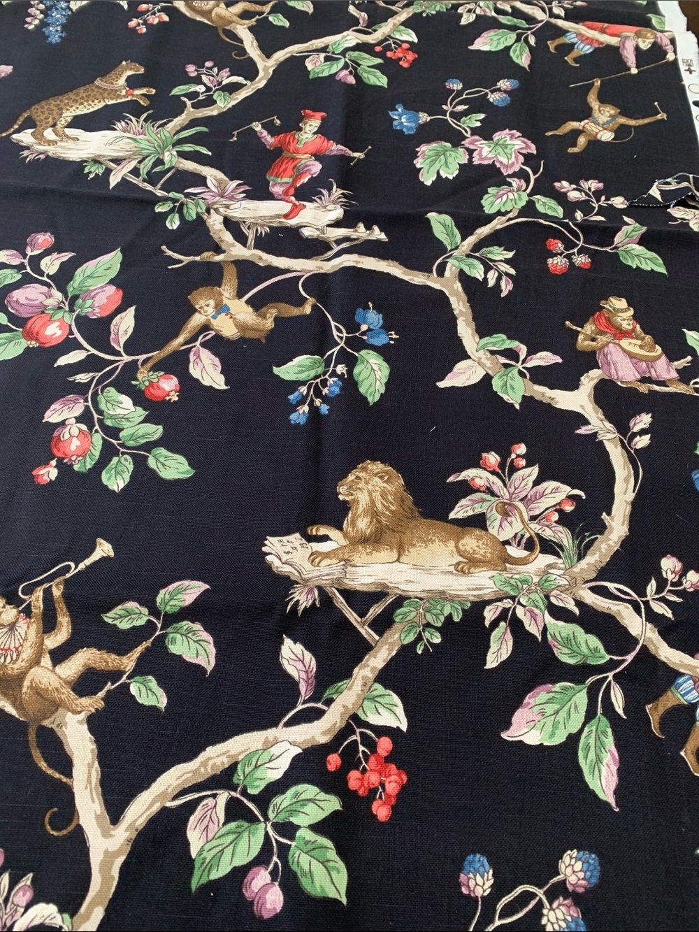 Whimsical designer fabric- black with monkeys lions and jesters.